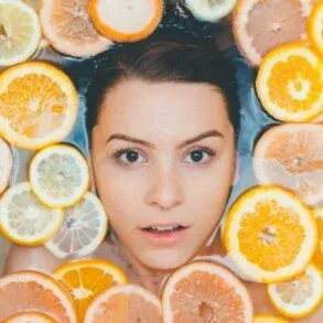skincare routine-girl face surrounded by citrus fruits